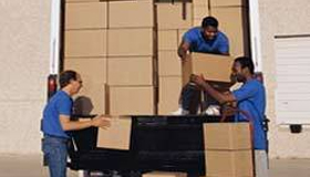 In this image you can some people for unloading a truck by The Express Cargo Packers and Movers in Delhi.